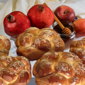 Round Rosh Hashana challahs with pomegranates, apple and honey