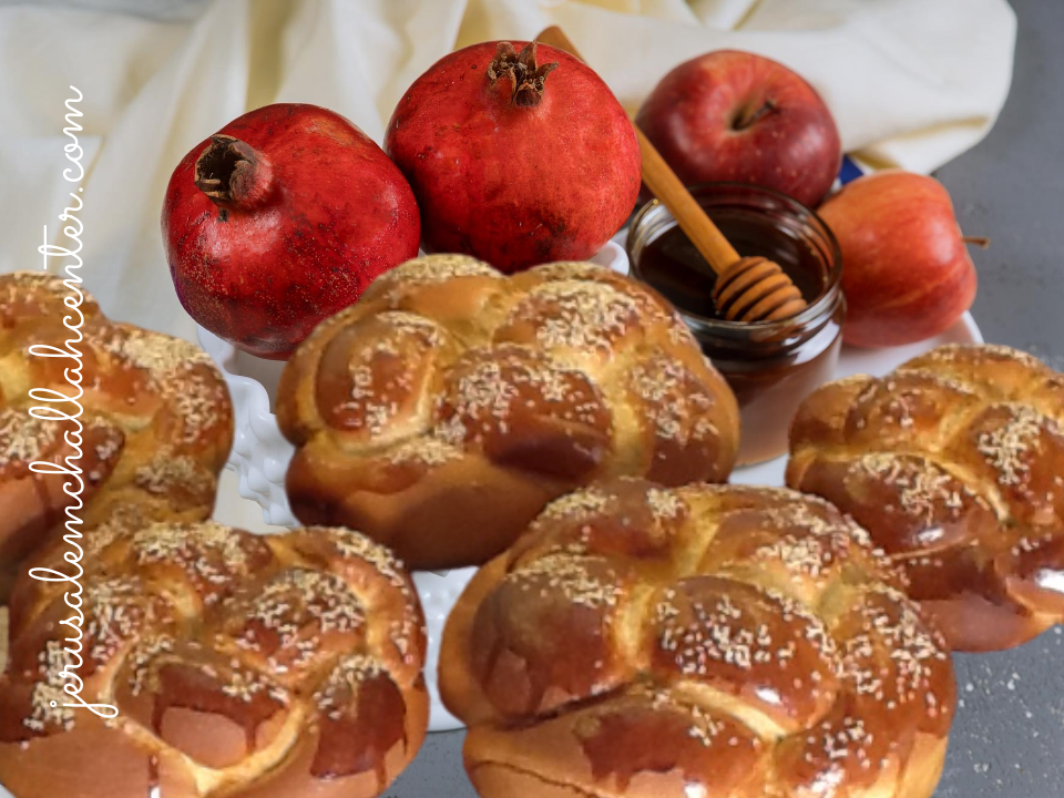Round Rosh Hashana challahs with pomegranates, apple and honey